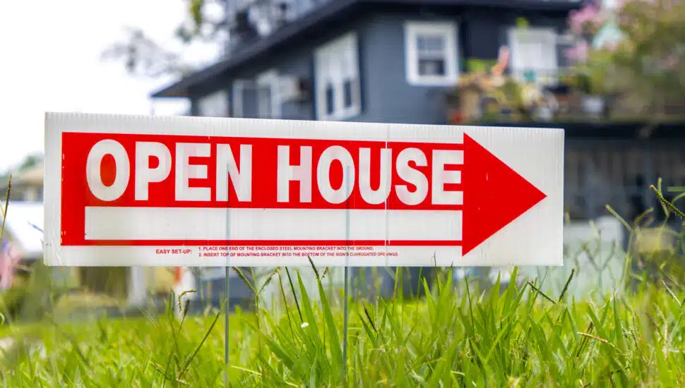 Open house sign on grass.