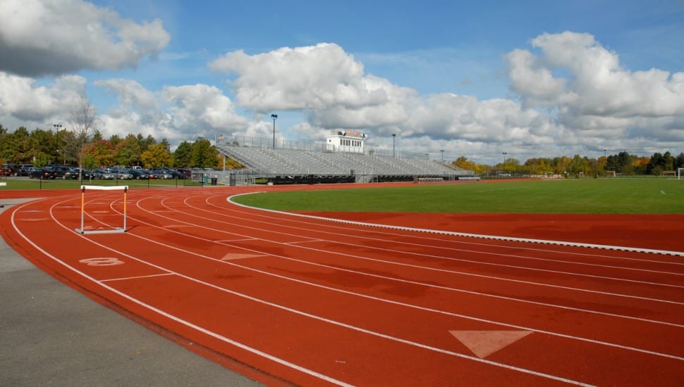 An empty running track with hurdles