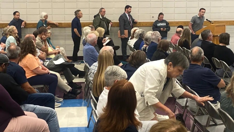 Residents line up to speak about a warehouse project on the former Franklin Mint property.