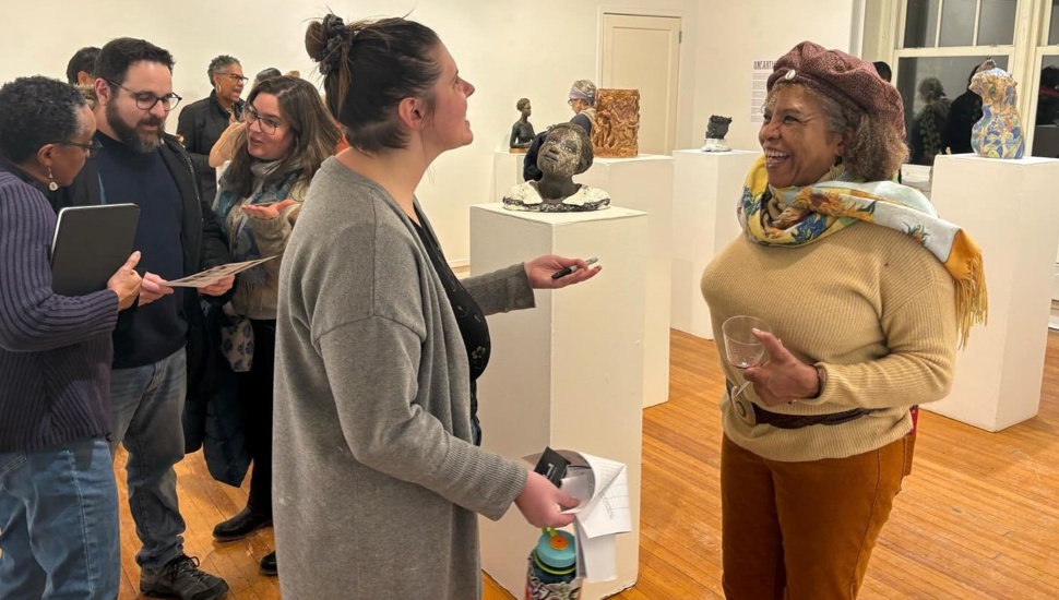 People mingle in an art gallery.