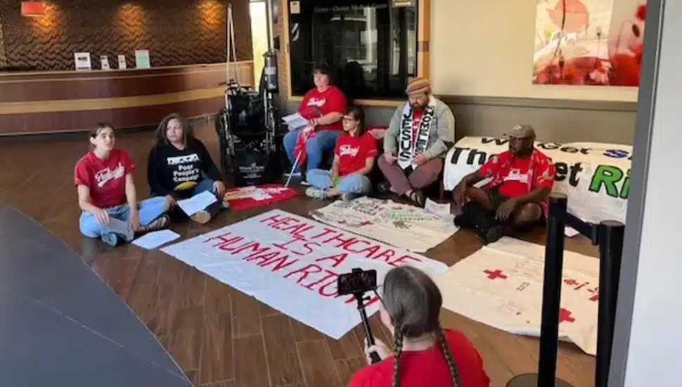 Protesters with the advocacy group Put People First PA! staged a sit-in at Crozer-Chester Medical Center Monday.