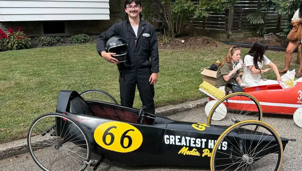 Dom Glisson poses with the grand prize-winning vehicle from Greatest Hits Records and Books in Media.