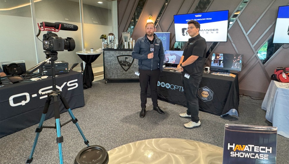 Man conducts interview in front of a camera.