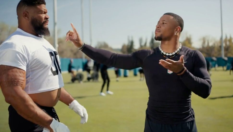 Philadelphia Eagle Saquon Barkley appears in a commercial.