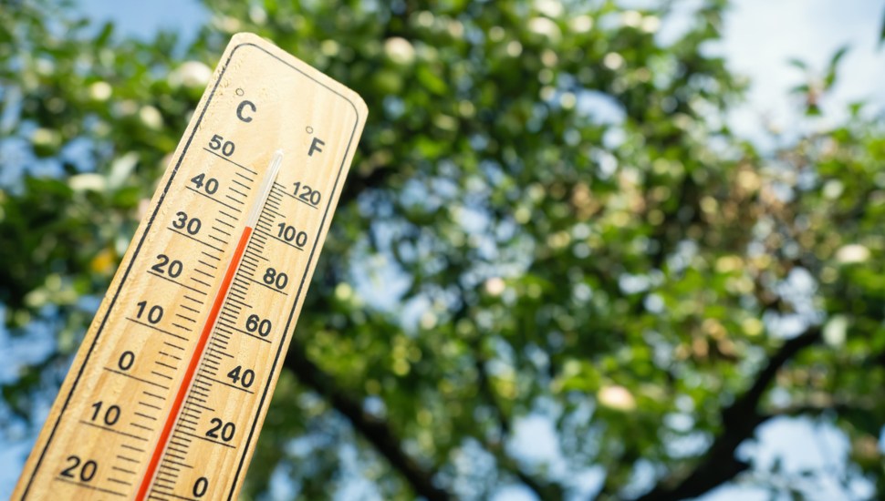 A thermometer outside showing temperatures approaching the 90s.