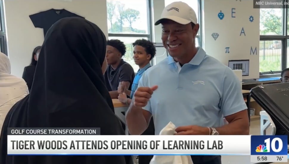 Tiger Woods speaks with a woman at the new Learning Lab at the Cobbs Creek Golf Course.