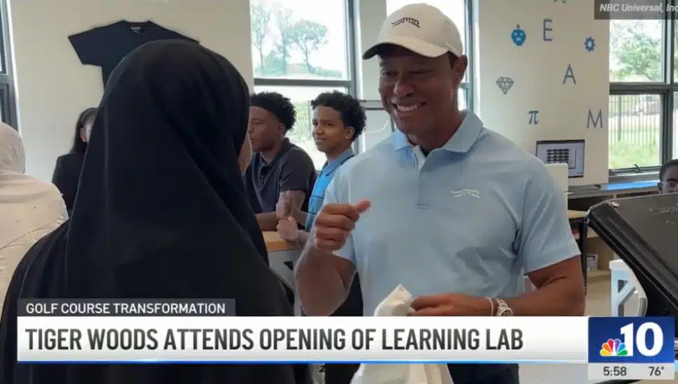 Tiger Woods speaks with a woman at the new Learning Lab at the Cobbs Creek Golf Course.