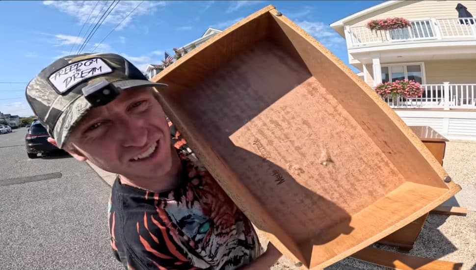 Tucker Upper holds a discarded item from wealth Jersey Shore towns.