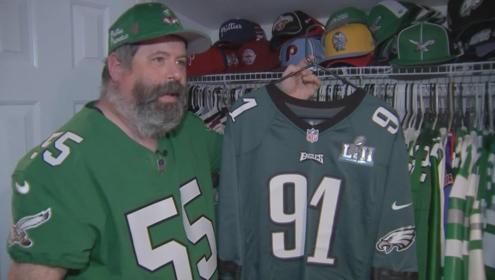 Neil Beck holds up his most prized Eagles jersey.
