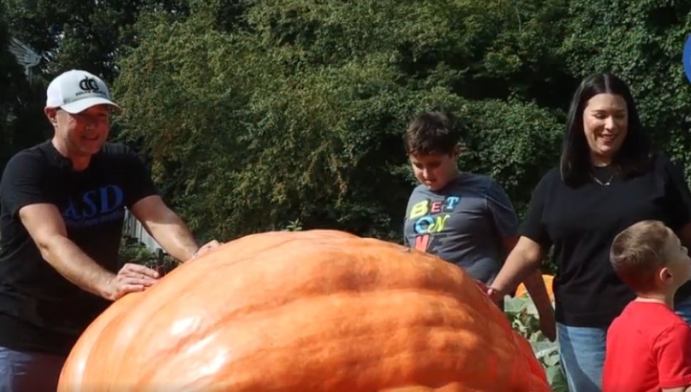 The Meehan family in Broomall gather around their giant pumpkin.
