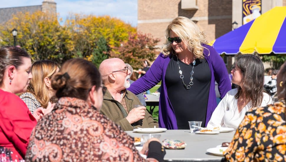 West Chester University President Laurie Bernotsky talks with university staff at a reception on campus following her recent fall address.