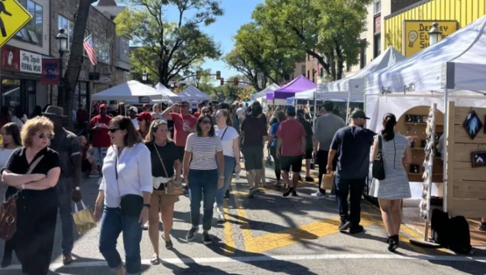 A crowd outside on a sunny day enjoying the Oktoberfest in Ambler.
