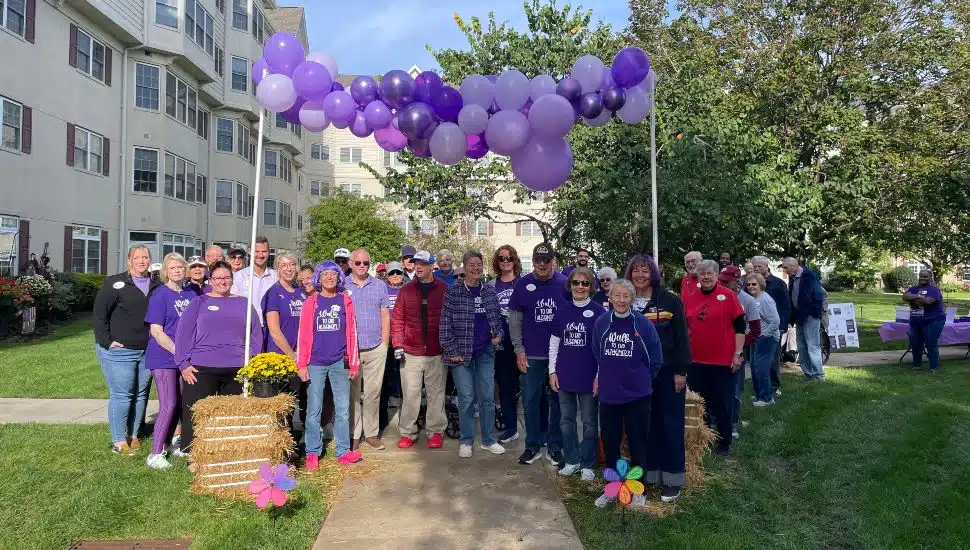 A group of residents and staff gather at the end of the Freedom Village Alzheimer's Walk.