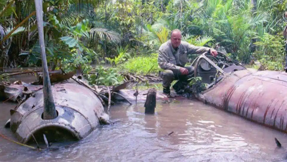 Alfred "Fred" Hagenwith a crashed P38 Lightning in the Ramu River Valley of Palau New Guinea.
