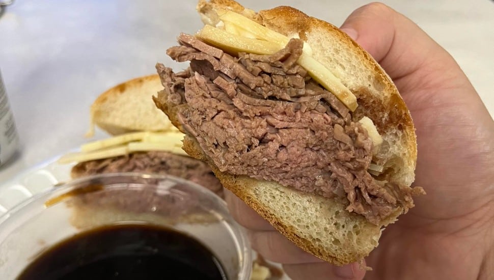 A hand holds a roast beef sandwich from Jerry's Roastbeef and More at Booth's Corner in Garnet Valley.