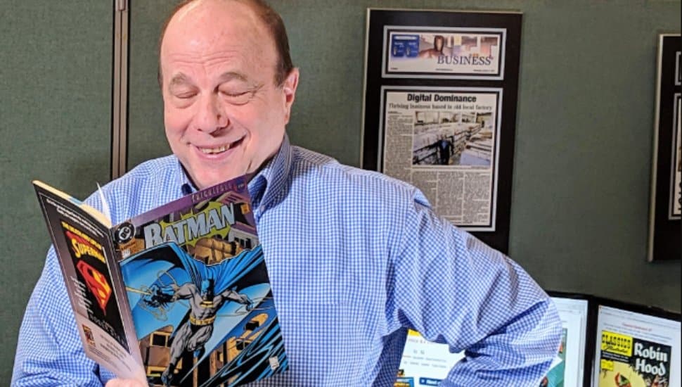 Comic pioneer Jim Drucker reads from a comic book.