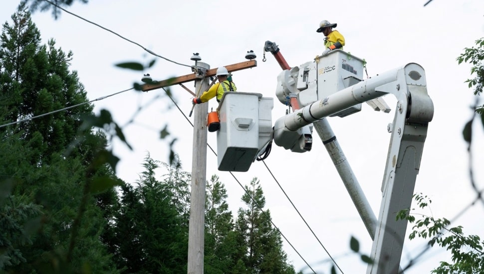 Utility workers work on electrical lines.