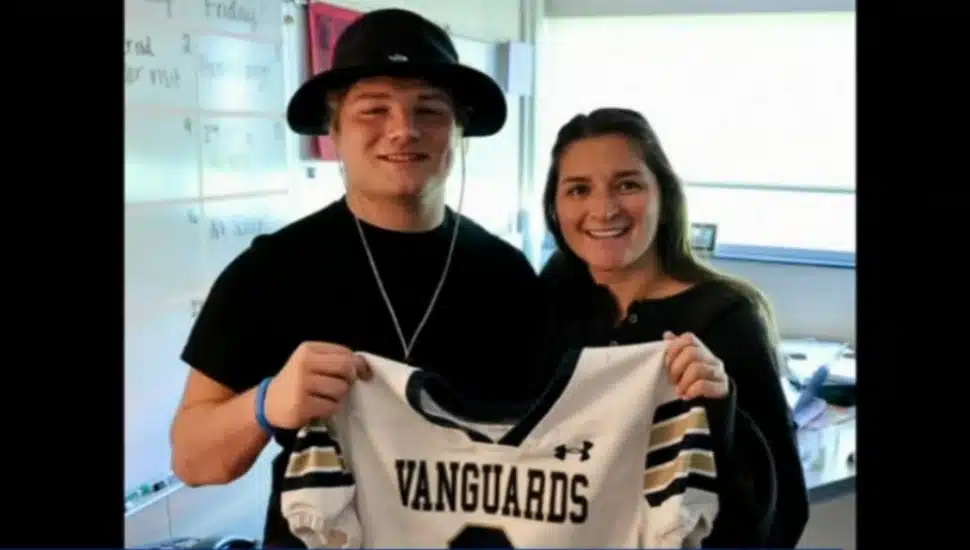 Sun Valley High School senior Rider Strickland presents his football jersey to his teacher.