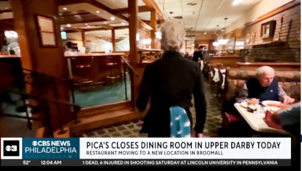 The inside of Pica's dining room in Upper Darby as a waitress brings food.
