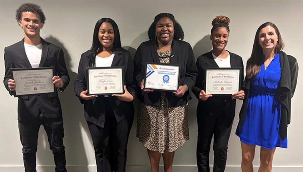 High school students pose for group photo with certificates in hand.