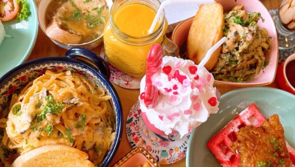 A table filled with entrees, beverages and desserts from Vanilla Cafe.