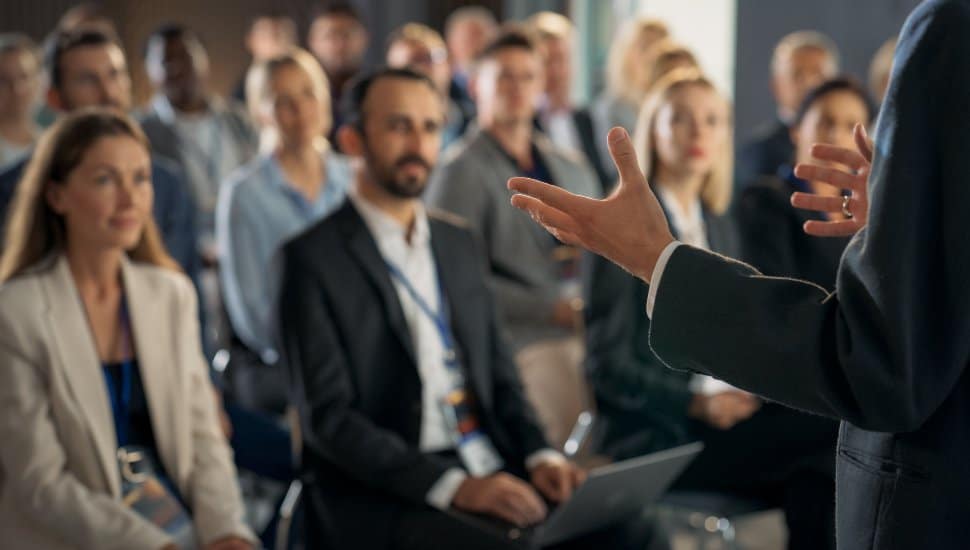 Speaker addressing an attentive audience during a community presentation or lecture.
