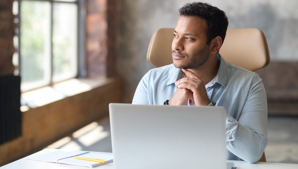Man concentrating at his laptop computer.