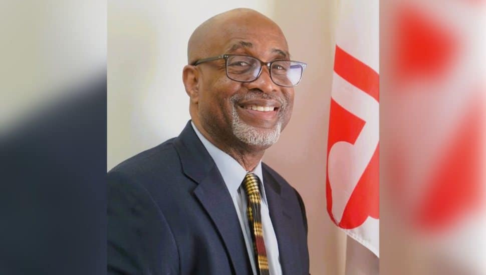 Portrait of Alverne “Chet” Chesterfield, a Wilmington University alumnus, standing confidently in front of a state-capital building after his appointment to the Maryland State Board of Education.
