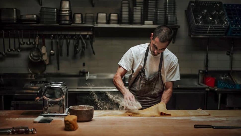 A chef prepares a food item at Andiario.