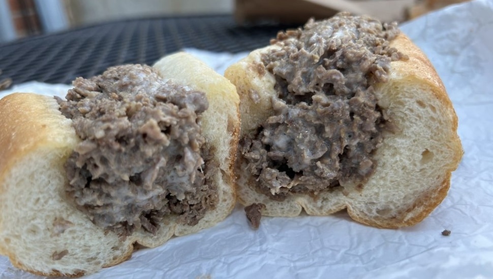 A cheesesteak cut in half.