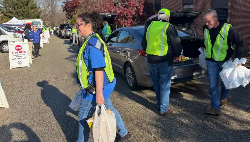 Volunteers remove food donations from vehicles at Saturday’s Delaware County Community Food Drive.