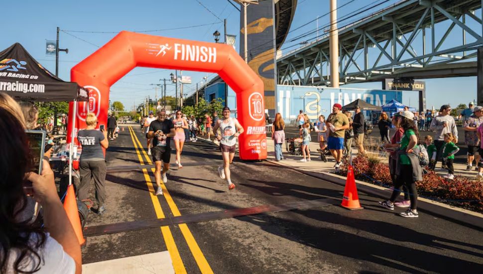 Runners cross the finish line of the Delco 10-Miler at Subaru Park in Chester on Sunday, Sept. 28, 2025.