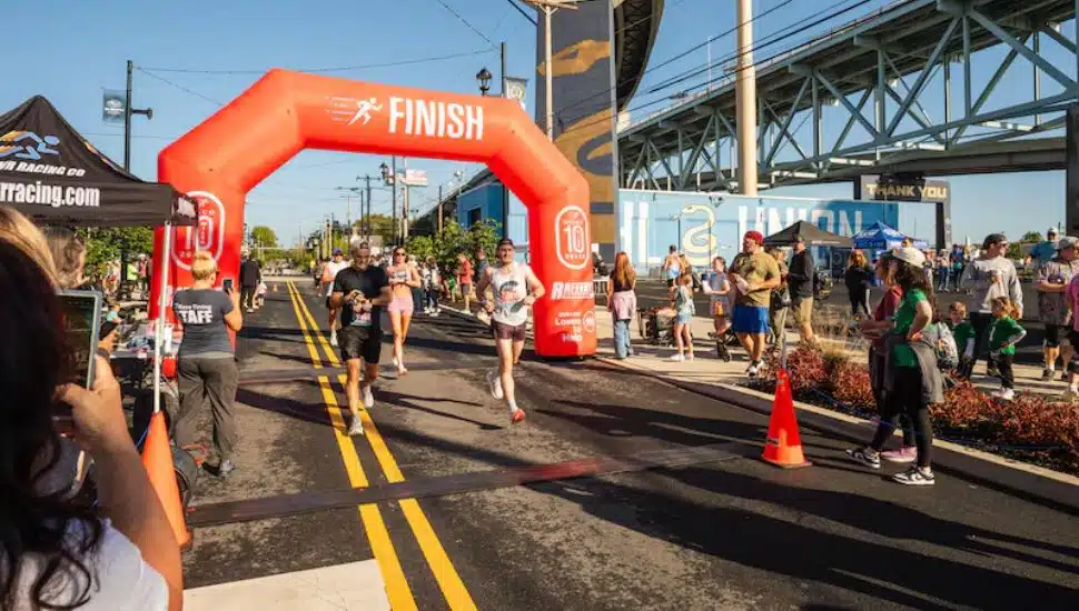 Runners cross the finish line of the Delco 10-Miler at Subaru Park in Chester on Sunday, Sept. 28, 2025.