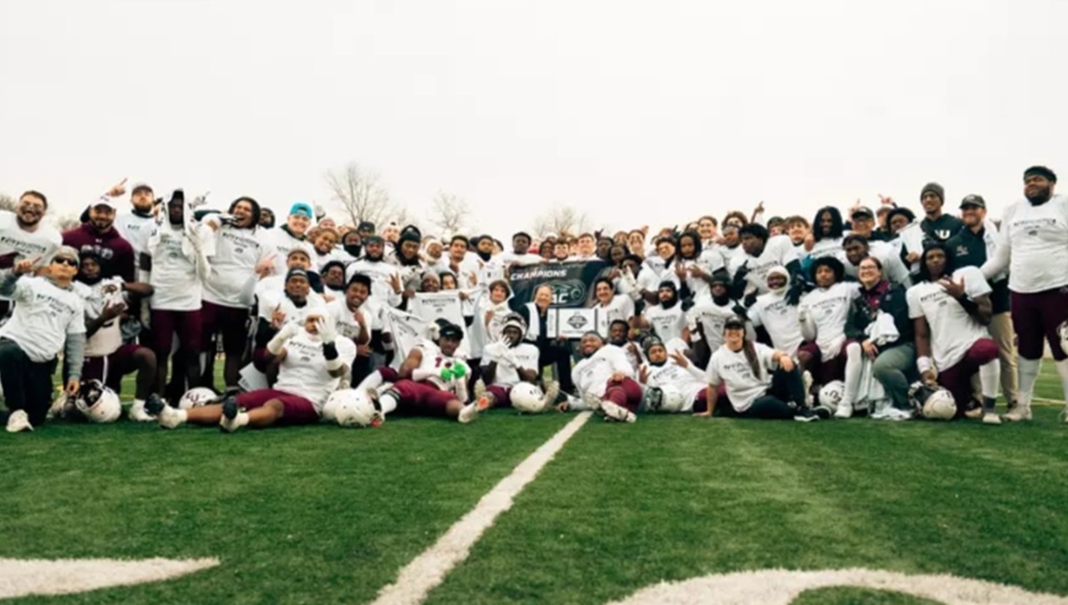 Football team poses for championship picture.
