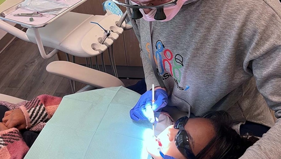 Dentist cleans a child's teeth.
