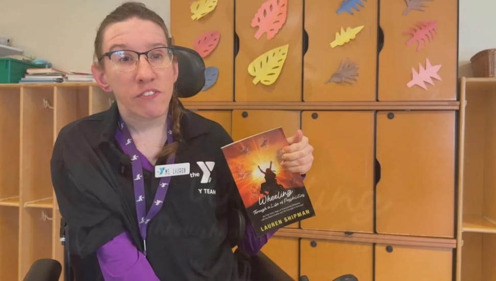 Haverford author Lauren Shipman holds up a copy of her book, “Wheeling Through a Life of Possibilities.”