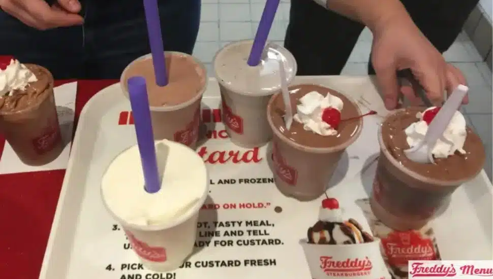 Several milkshakes of different flavors on a tray.