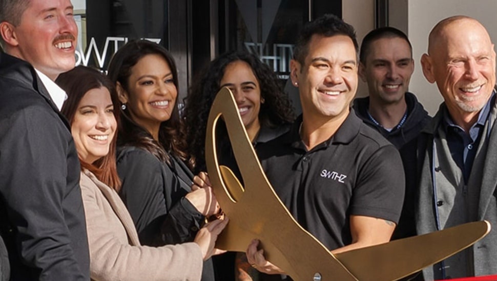 Company's founders cut ribbon on new location.