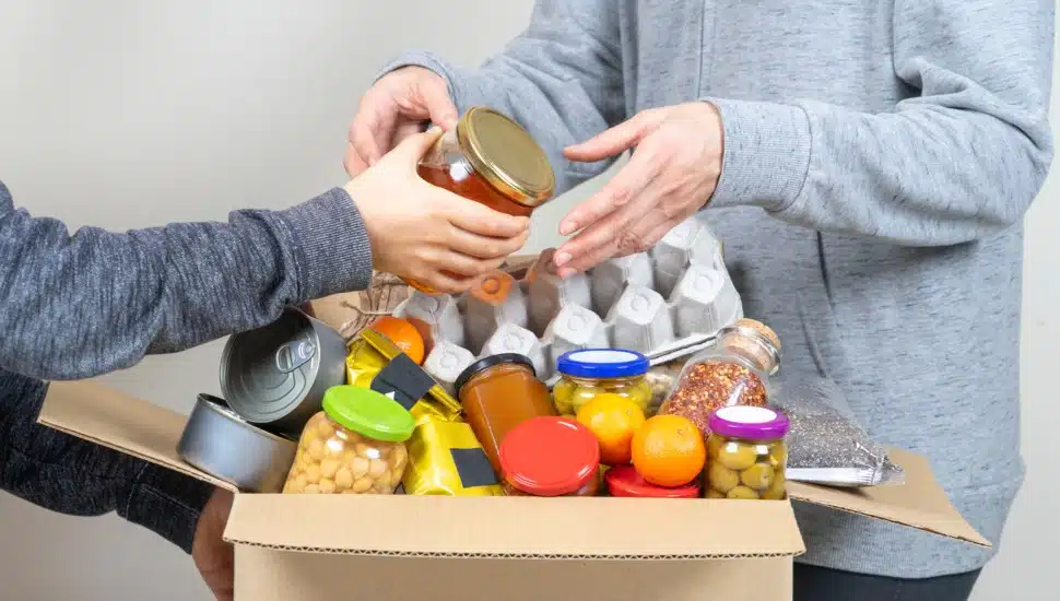 Volunteers fill of box with donated food.