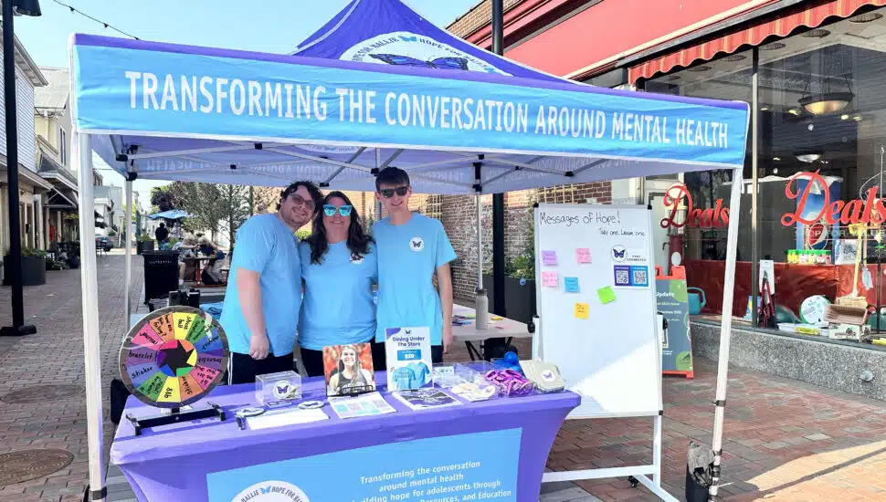 Christine Jackson with her sons Scott Jackson (left) and Matthew Jackson (right) at the Hope for Hallie tent during a community event.