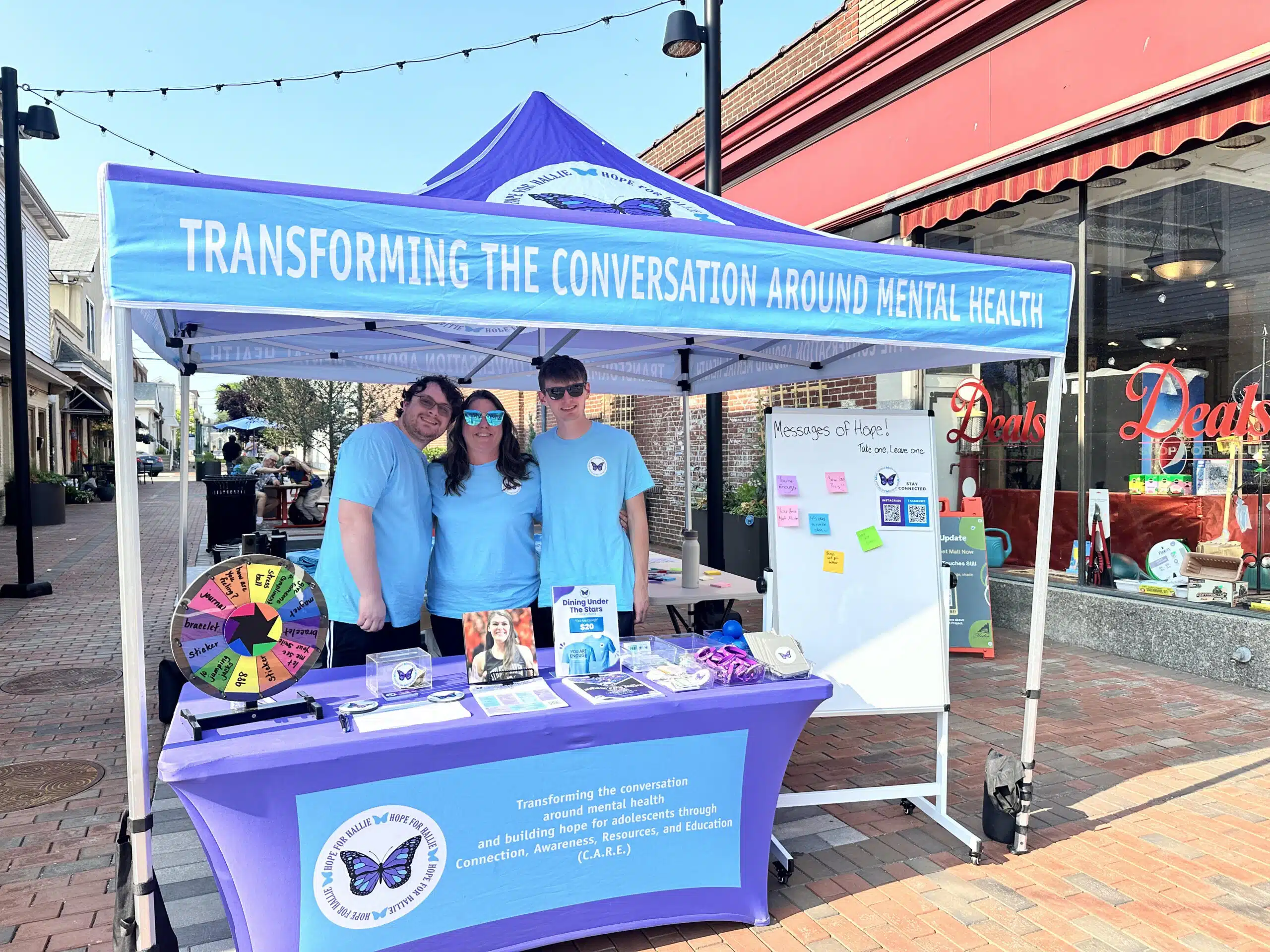 Christine Jackson with her sons Scott Jackson (left) and Matthew Jackson (right) at the Hope for Hallie tent during a community event.