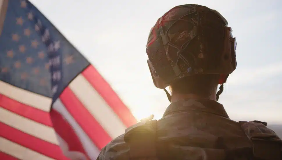 American Military Observes The US Flag At Sunset During Veteran Day Holiday.