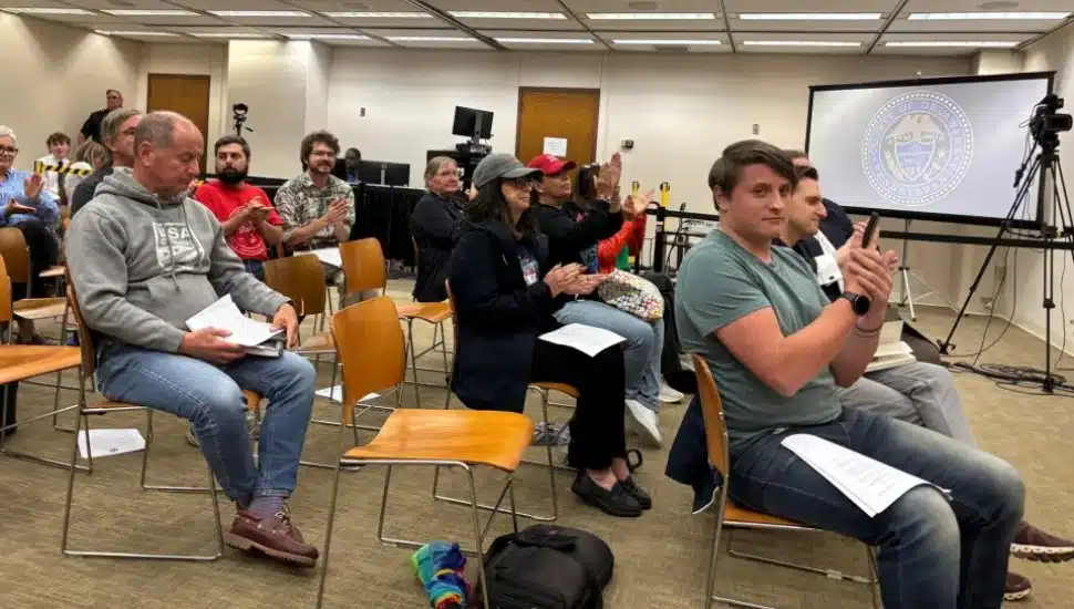 Audience members at the September Delaware County Council meeting applaud passage of a resolution creating the Human Relations Commission.