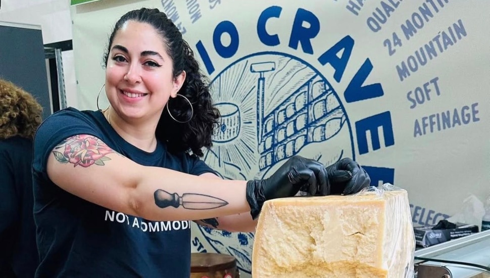 Cheesemonger Emilia DAlbero has her hands on a block of cheese.
