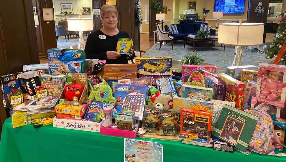 A woman stands with donated Freedom Village at Brandywine items for Project Snowflake.