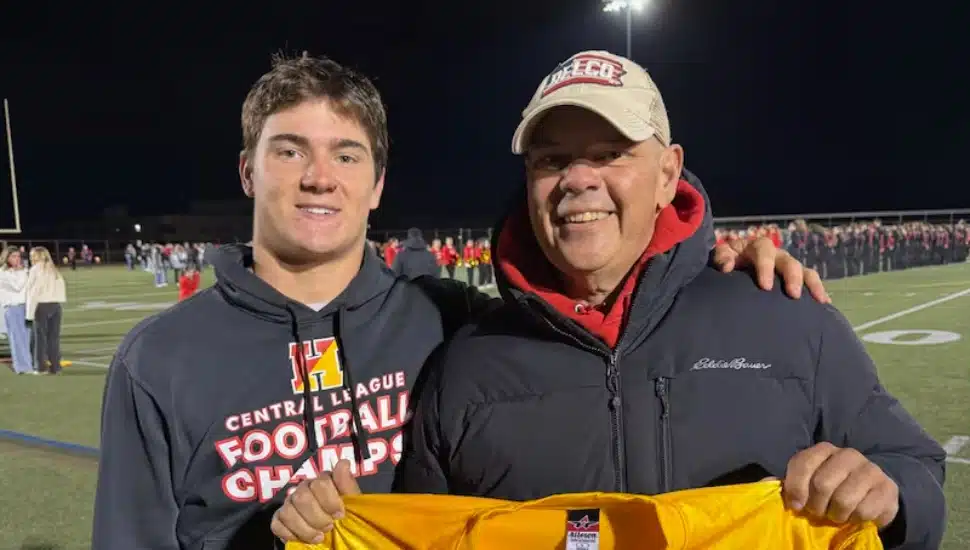 Liam Taylor with his father, Eric, holding up his Haverford Ford’s jersey.