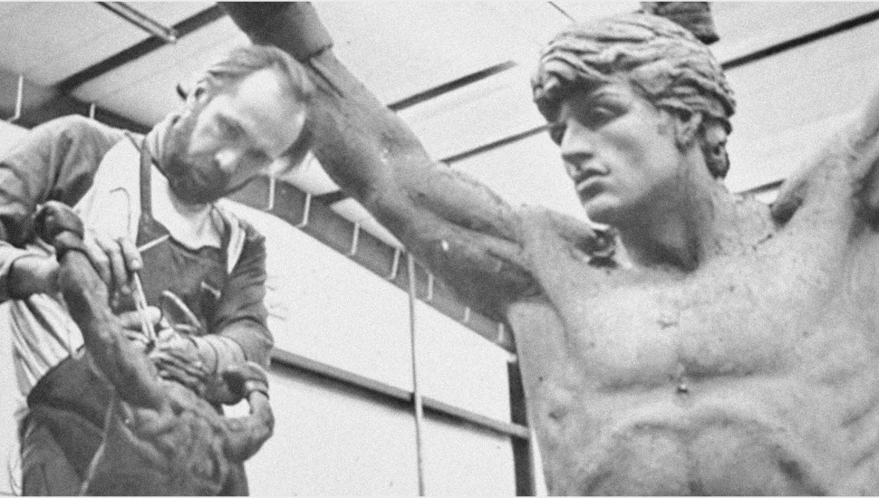 An artist works on the Rocky statue,