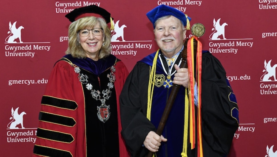 College president pictured with department chair at commencement.