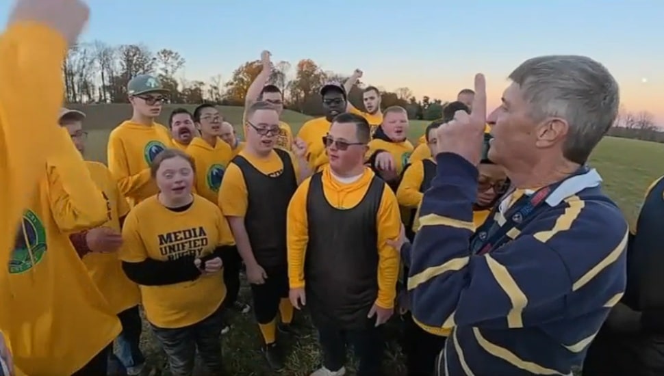 Matt Heavens stands with his Media Unified Rugby team.