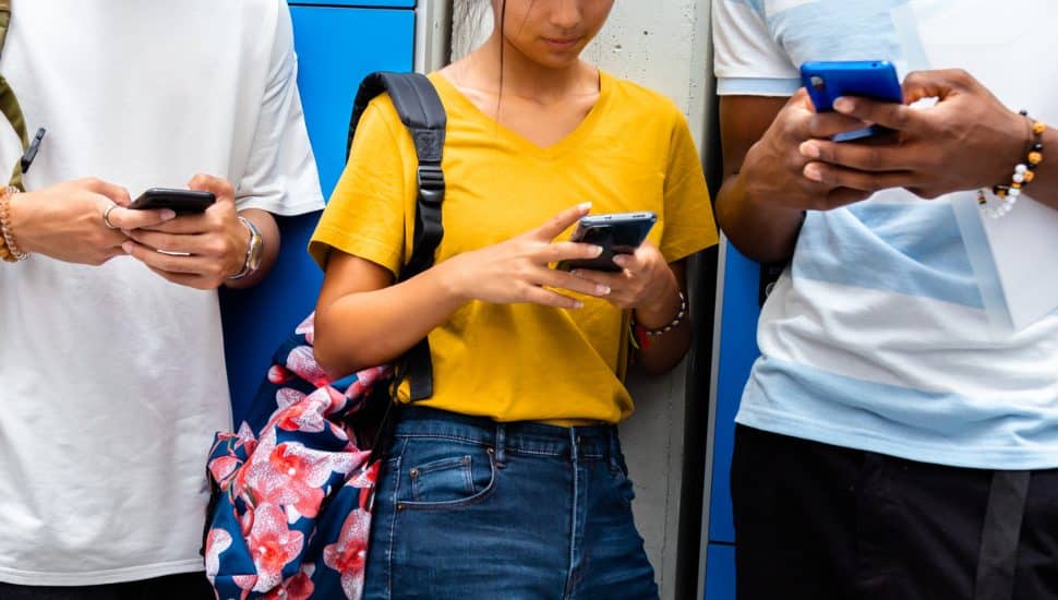 Students at school using cell phones.